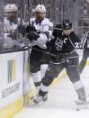 Los Angeles Kings right wing Dustin Brown, right, battles San Jose Sharks center Patrick Marleau for the puck during the first period in Game 4 of an NHL hockey first-round playoff series in Los Angeles, Thursday, April 24, 2014. (AP Photo/Chris Carlson)