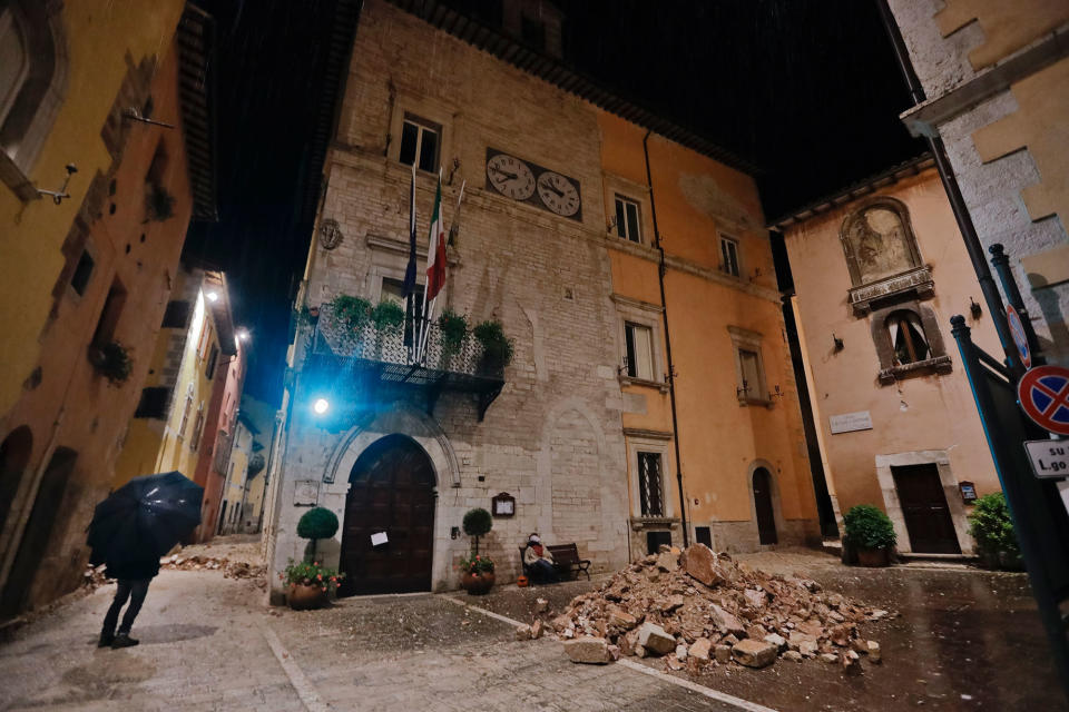 People wander around Visso after the quake