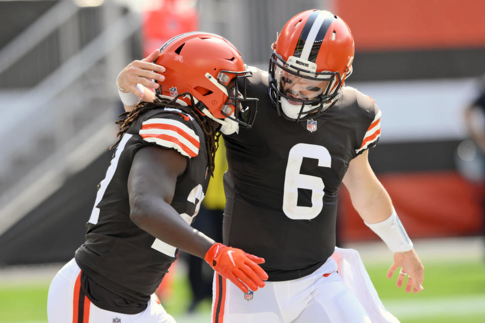 Cleveland Browns quarterback Baker Mayfield (6) congratulates running back Kareem Hunt after Hunt scored on a 9-yard touchdown pass during the first half of an NFL football game against the Washington Football Team, Sunday, Sept. 27, 2020, in Cleveland. (AP Photo/David Richard)