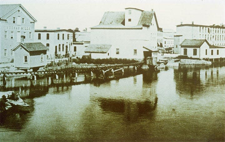 The Neenah Mills (building on the left) was built in 1850 to 1851 by John R. and Harvey L. Kimberly.