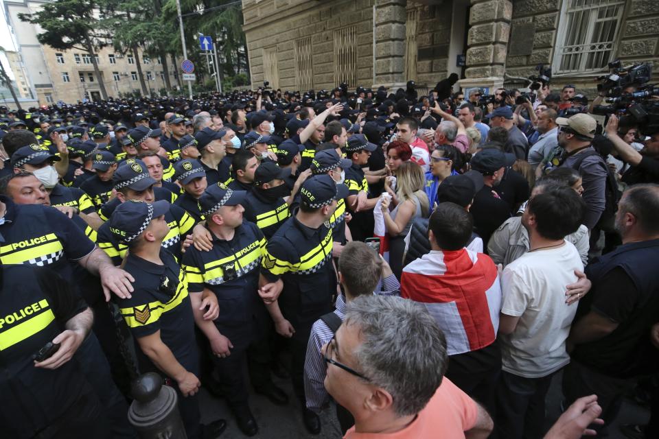 Police face demonstrators during an opposition protest against "the Russian law" near the Parliament building in Tbilisi, Georgia, on Wednesday, May 1, 2024. Protesters denounce the bill as "the Russian law" because Moscow uses similar legislation to stigmatize independent news media and organizations critical of the Kremlin. (AP Photo/Zurab Tsertsvadze)