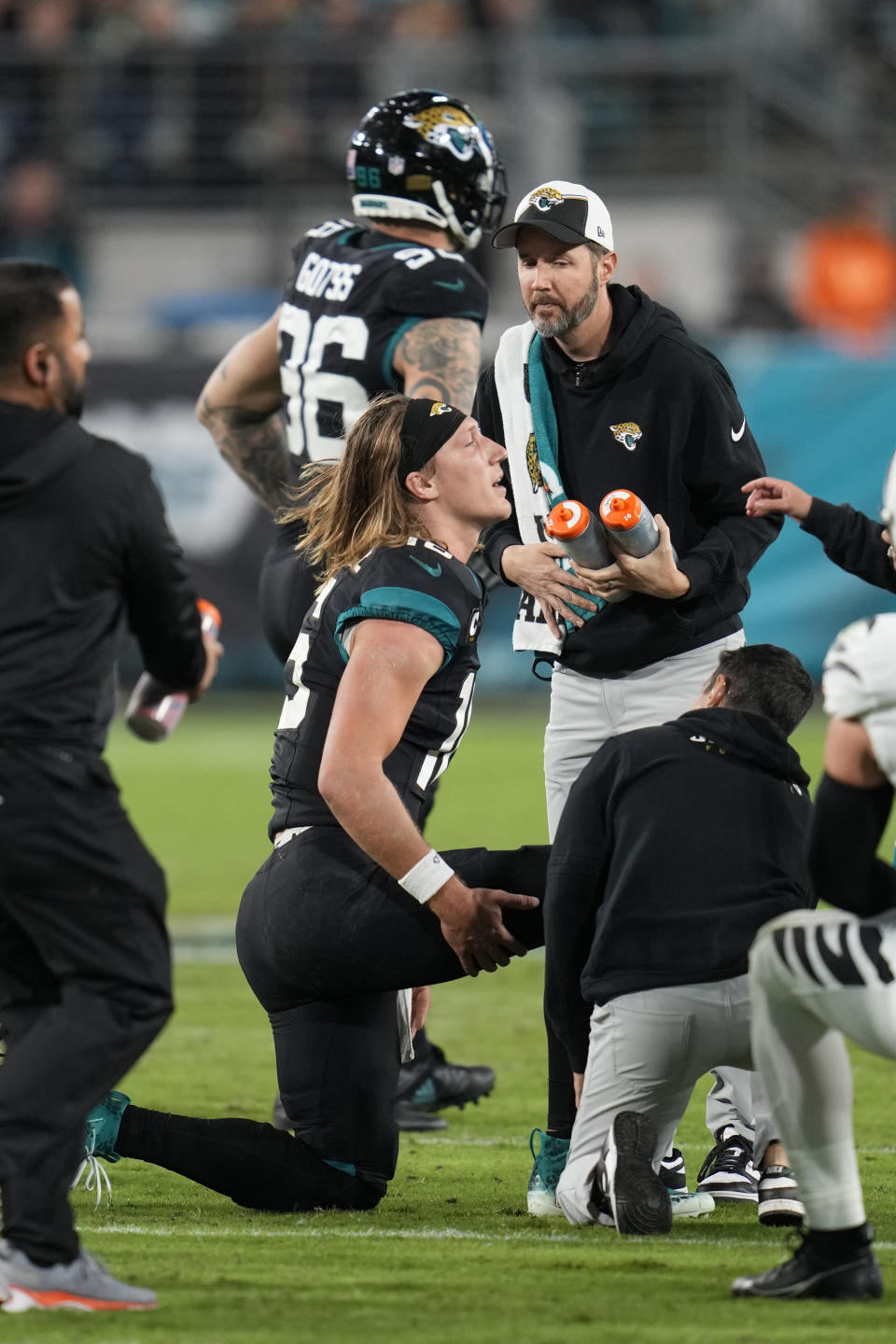 Jacksonville Jaguars quarterback Trevor Lawrence (16) is attended on the field after he was injured during the second half of an NFL football game against the Cincinnati Bengals, Monday, Dec. 4, 2023, in Jacksonville, Fla. (AP Photo/John Raoux)