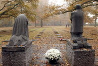 FILE - In this Nov. 11, 2003 file photo, a sculpture entitled "Mourning Parents" by German artist Kaethe Kollwitz looks over a German World War I cemetery in Vladslo, Belgium. German Chancellor Angela Merkel will mark the 100th anniversary of the end of World War I on French soil, and President Frank-Walter Steinmeier will be in London’s Westminster Abbey for a ceremony with the queen. But in Germany, there are no national commemorations planned for the centenary of the Nov. 11 armistice that brought an end to the bloody conflict that killed more than 2 million of its troops and left 4 million wounded. That’s because the armistice did not bring peace to Germany. (AP Photo/Virginia Mayo, File)