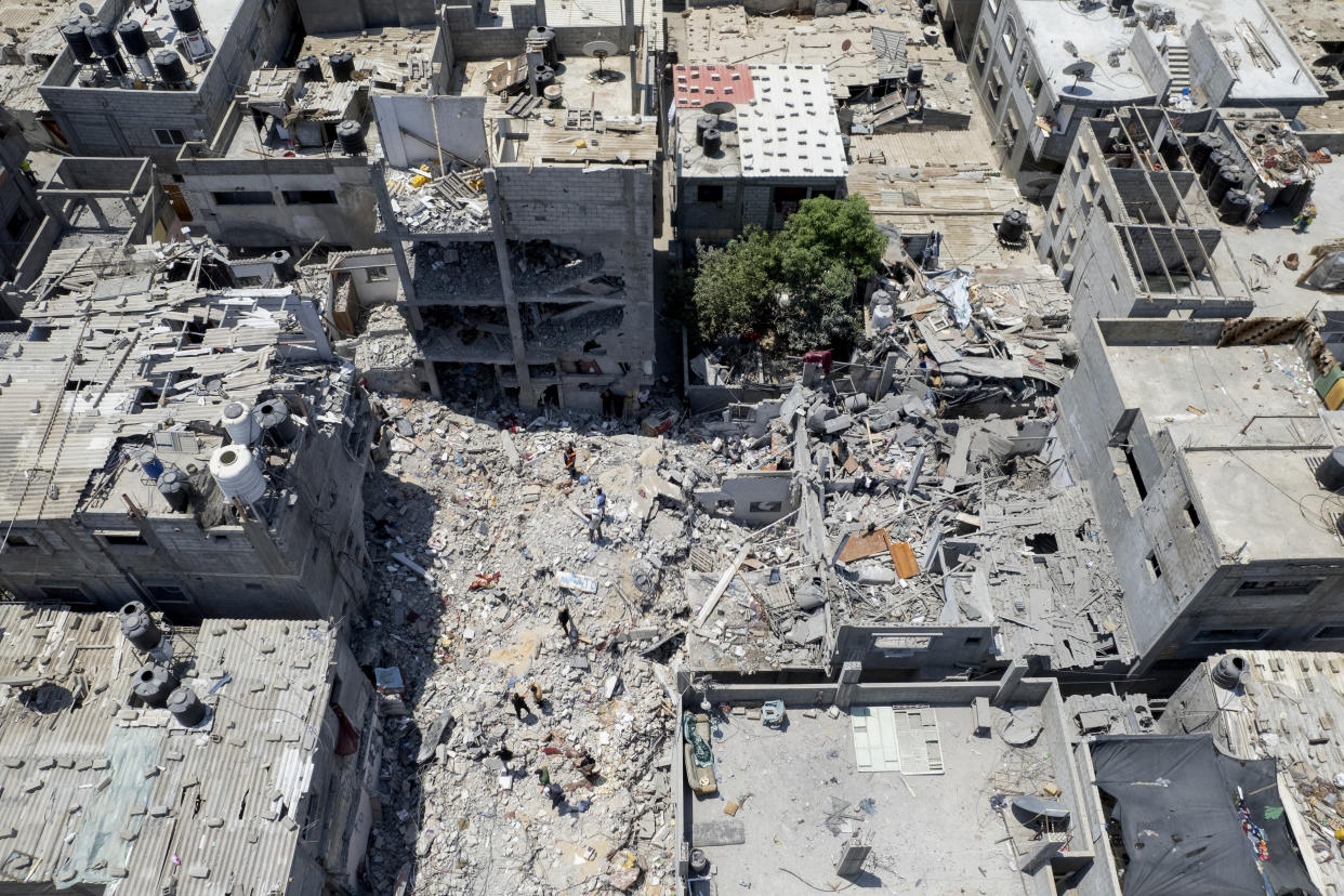 FILE - Palestinians search through the rubble of a building in which Khaled Mansour, a top Islamic Jihad militant, was killed in an Israeli airstrike on Sunday, in Rafah, southern Gaza Strip, Monday, Aug. 8, 2022. The death toll from last weekend's fighting between Israel and Gaza militants has risen to 47, after a man died from wounds sustained during the violence, the Health Ministry in Gaza said Thursday, Aug. 11, 2022. (AP Photo/Hatem Moussa, File)