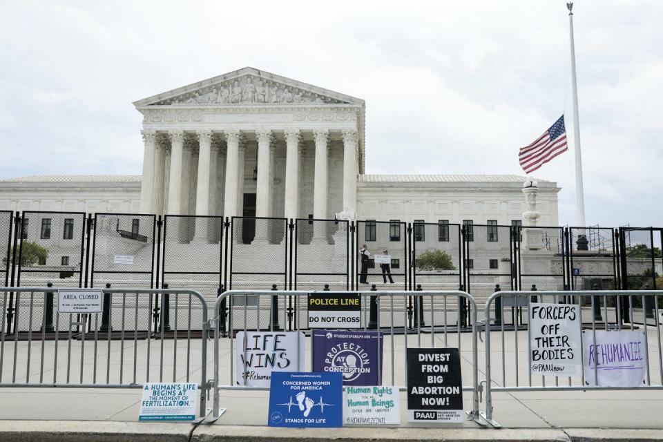 <span class="caption">Signs belonging to anti-abortion protesters sit in front of a fenced U.S. Supreme Court building on May 16, 2022.</span> <span class="attribution"><a class="link " href="https://media.gettyimages.com/photos/signs-belonging-to-antiabortion-protesters-sit-along-a-bike-fence-in-picture-id1397560961?s=2048x2048" rel="nofollow noopener" target="_blank" data-ylk="slk:Anna Moneymaker/Getty Images;elm:context_link;itc:0;sec:content-canvas">Anna Moneymaker/Getty Images</a></span>