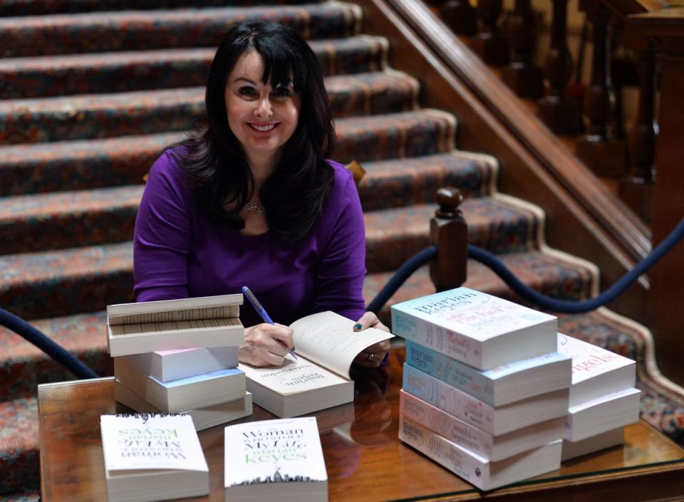 Keyes signs copies of her books at the Althorp Literary Festival, 2015 (PA)