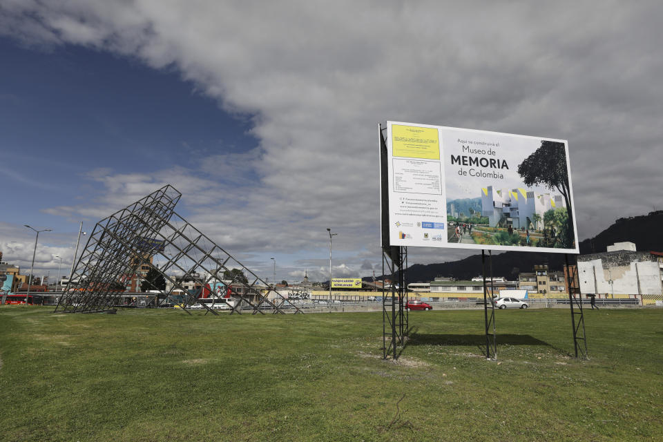 A sign announces the spot where Colombia's government plans to build a museum paying homage to the many victims of the country's long civil conflict in Bogota, Colombia, Tuesday, Dec. 17, 2019. The Museum of memory has become a very public feud because of the director overseeing it: longtime history professor Darío Acevedo, who has expressed a view of the conflict that critics say could excuse the state of much of its responsibility for the violence. (AP Photo/Fernando Vergara)