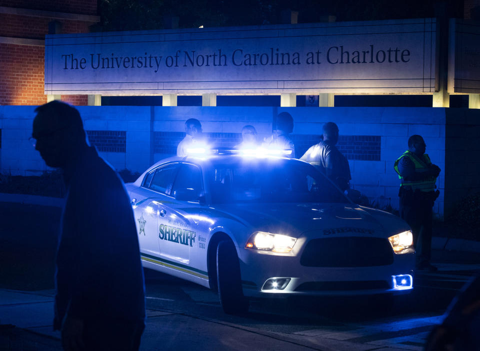 FILE - In this April 30, 3019 file photo, police secure the main entrance to UNC Charlotte after a fatal shooting at the school, in Charlotte, N.C. Most of the students who commit deadly school attacks were bullied, had a history of disciplinary trouble and their behavior concerned others, but it wasn’t reported. That’s according to a comprehensive study by the U.S. Secret Service’s National Threat Assessment Center of 41 school attacks since the 1999 Columbine High School Shooting.(AP Photo/Jason E. Miczek)