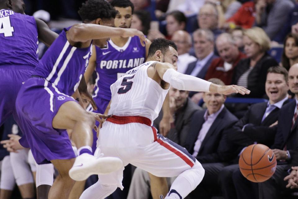 Gonzaga guard Nigel Williams-Goss (5) and Portland guard Rashad Jackson, left, go after the ball during the first half of an NCAA college basketball game in Spokane, Wash., Saturday, Jan. 21, 2017. (AP Photo/Young Kwak)