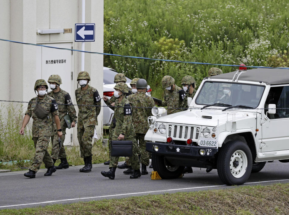 Members of Japan's Self Defense Force gather near a firing range on a Japanese army base following a deadly shooting in Gifu, central Japan, Wednesday, June 14, 2023. An army trainee was arrested Wednesday after allegedly shooting three fellow soldiers at the army base, officials said. (Kyodo News via AP)