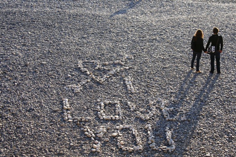 This file illustration photo shows people holding hands near an inscription reading 'I love you', made with stones, on Nice beach in southern France, on November 26, 2009. Asexuality is still largely misunderstood, particularly in countries where sex is splashed all over magazines, films and on television, and very few studies have been done on the subject