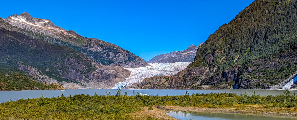 A photo of Mendenhall Glacier across a lake.