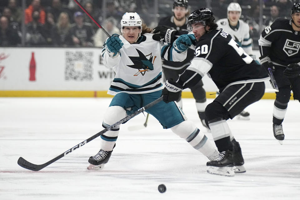 San Jose Sharks left wing Alexander Barabanov, left, and Los Angeles Kings defenseman Sean Durzi battle for the puck during the first period of an NHL hockey game Wednesday, Jan. 11, 2023, in Los Angeles. (AP Photo/Mark J. Terrill)