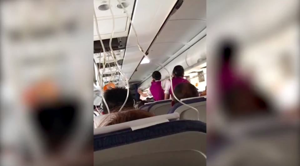 Disturbing footage from inside the plane reveals the moment the windscreen was ripped out. Source: Newsflare