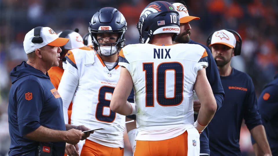 Payton talks with Stidham and Nix during the game. - Tyler Schank/Getty Images