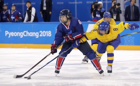 Ice Hockey – Pyeongchang 2018 Winter Olympics – Women Preliminary Round Match - Sweden v Korea - Kwandong Hockey Centre, Gangneung, South Korea – February 12, 2018 - Choi Yu-jing of Korea in action with Annie Svedin of Sweden. REUTERS/Kim Kyung-Hoon