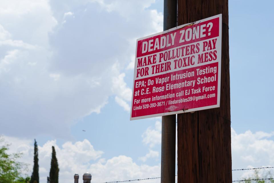 A sign reading "Deadly Zone? Make Polluters Pay For Their Toxic Mess" hangs outside Tucson Water well B-85 on July 15, 2022 in Tucson, AZ.