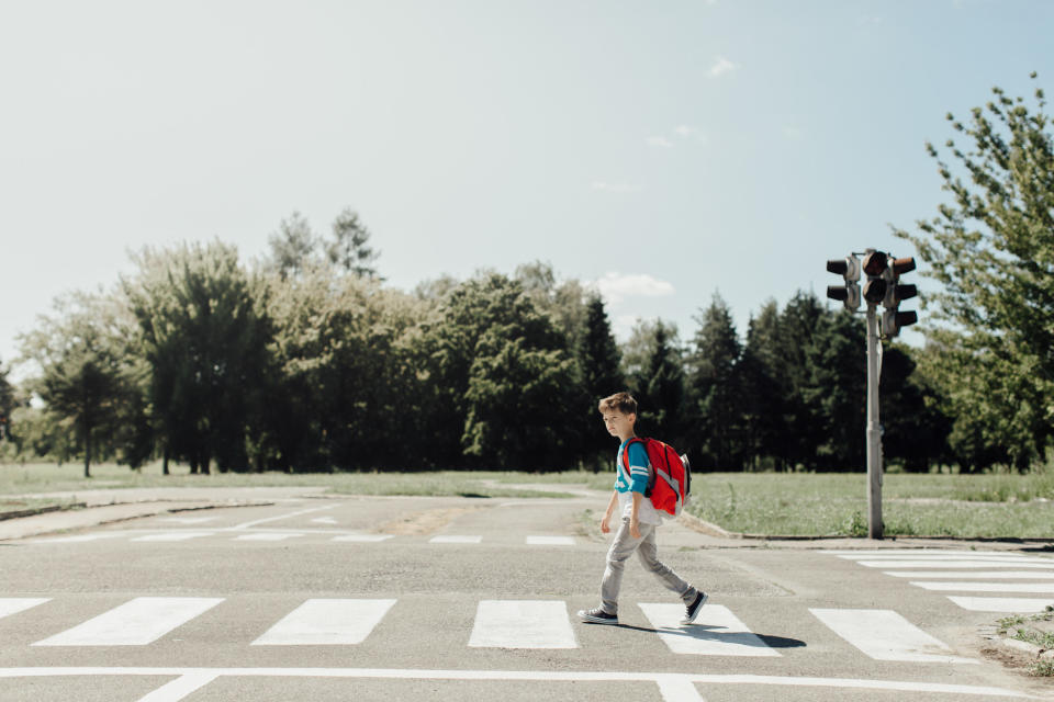 A young boy walking to school.