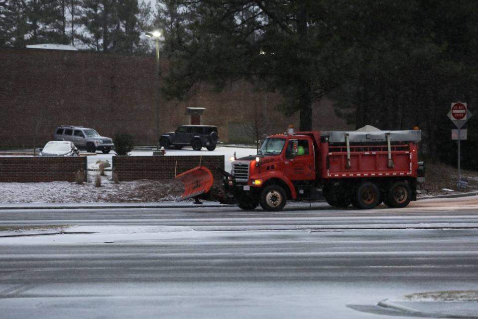 A snow plow truck exits drives onto Raleigh Road on its way to I-40 in Chapel Hill, N.C. on Sunday morning, Jan. 16 2022.