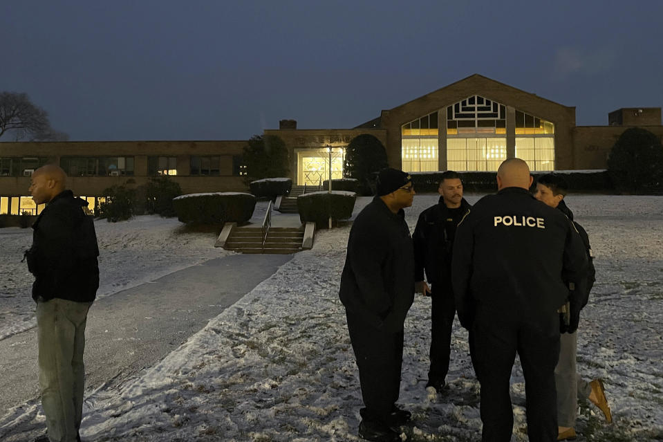 Albany police officers gather outside Temple Israel, Thursday, Dec. 7, 2023, in Albany, N.Y. A 28-year-old suspect was in police custody for allegedly firing two rounds from a shotgun outside the Jewish temple on Friday, just hours before the start of Hanukkah. Officials said no one was injured and police they did not know the man's motive.(AP Photo/Maysoon Khan)