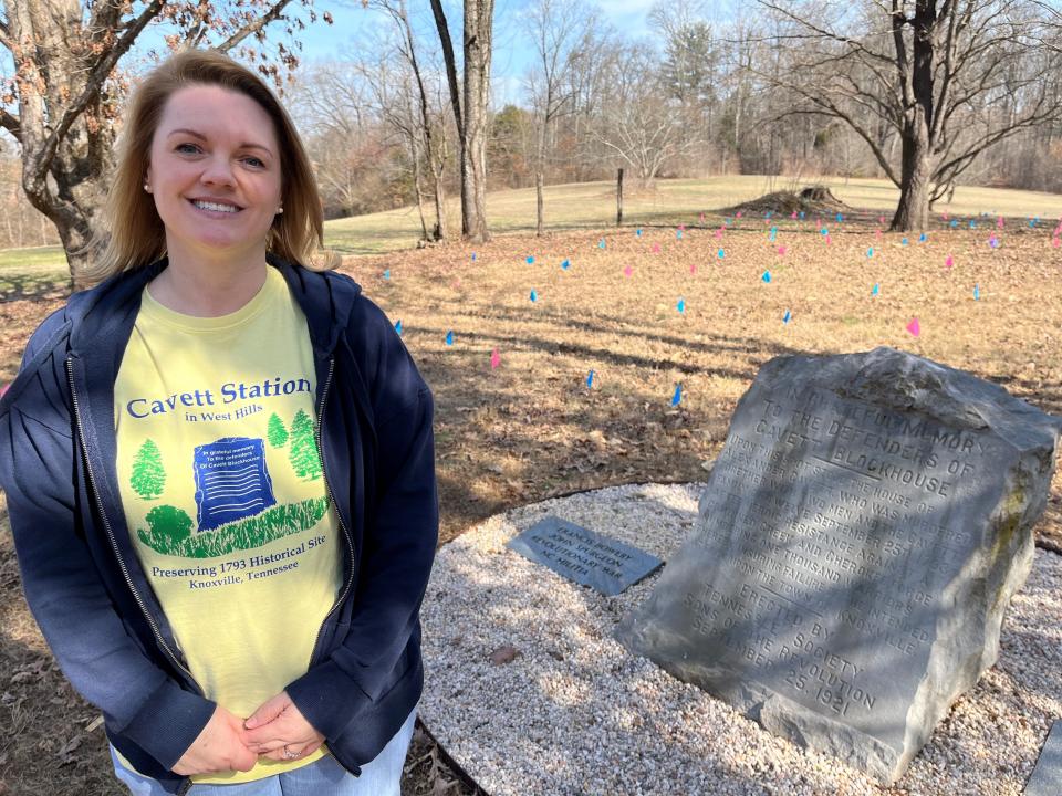 Amy Emert, who is writing two books about Mars Hill Cemetery, stands inside the cemetery grounds near a new marker on Feb. 7, 2023. She and some other cemetery volunteers and supporters are trying to make improvement to help better preserve the memory of those buried there.