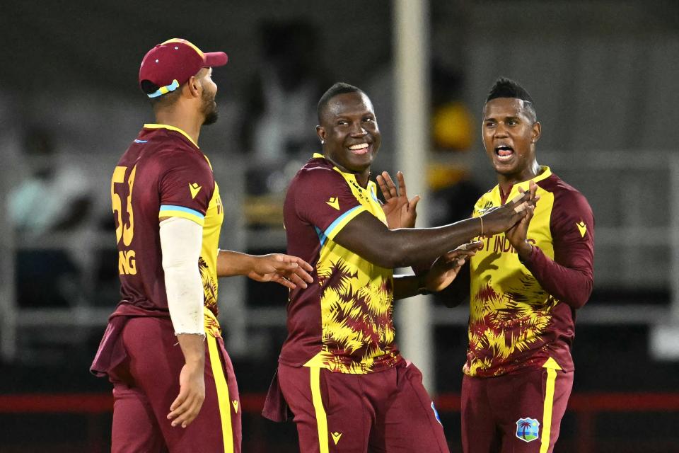 West Indies' Akeal Hosein (R) celebrates after dismissing Afghanistan's Azmatullah Omarzai with teammates West Indies' Brandon King (L) and Rovman West Indies' captain Rovman Powell (C) during the T20 cricket match between the West Indies and Afghanistan in St. Lucia, on June 17, 2024.