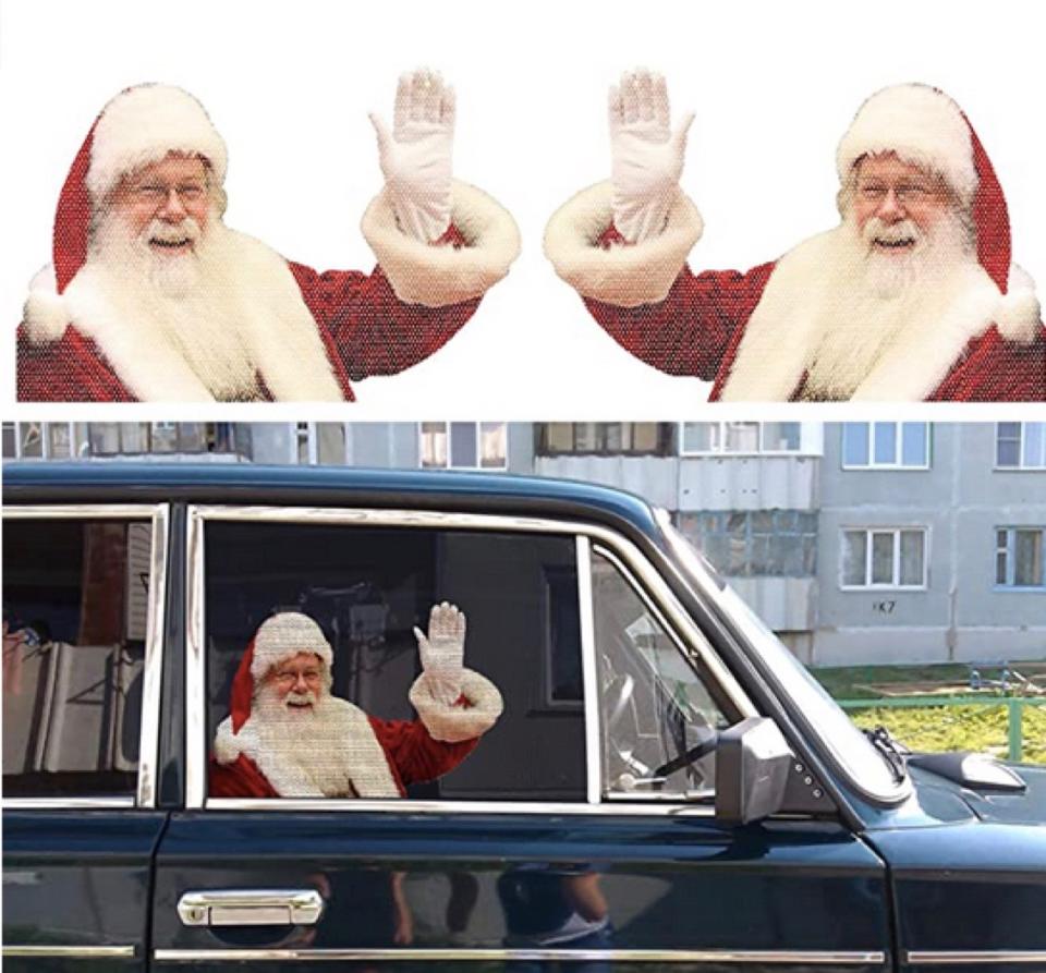 Decal of Santa waving on the passenger side window of a black car. 
