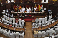 FILE- In this Nov. 22, 2019 file photo, Sri Lankan President Gotabaya Rajapaksa, center, stands during an oath-taking ceremony of his new cabinet members in Colombo, Sri Lanka. A proposed amendment to Sri Lanka’s constitution that will consolidate powers in the President’s hands has raised concerns about the independence of the country’s institutions and the impact on its ethnic minorities who fear their rights could be undermined by the majoritarian will.(AP Photo/Eranga Jayawardena, File)