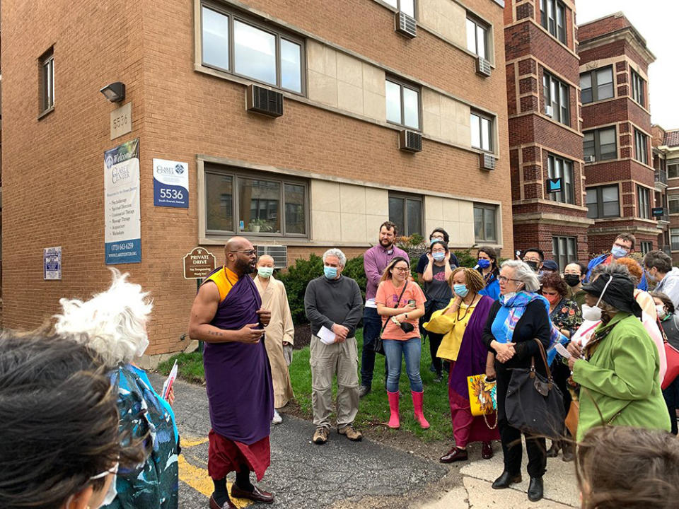 Heiwa no Bushi, center left, a BodhiChristo teacher from North Carolina, addresses the Chicago Interfaith Trolley Tour during a stop at the Claret Center, April 24, 2022, in Chicago. The tour, which took place on Orthodox Easter, was inspired by the convergence of Muslim, Jewish, Christian, Hindu, Jain, Sikh and Baha’i holidays in April. It was a chance to promote interfaith understanding, said organizers. (Bob Smietana/RNS via AP)