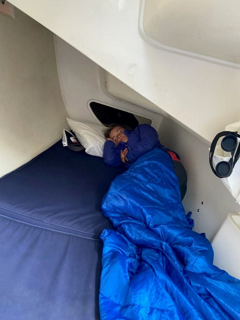 Merritt Sellers, 14, of Larkspur, California, and Harbor Springs, Michigan, rests during her off shift during the Bayview Mackinac Race. She and her father, Scott Sellers, sailed the 36-foot boat to win the doublehanded class on Sunday, July 17, 2022.