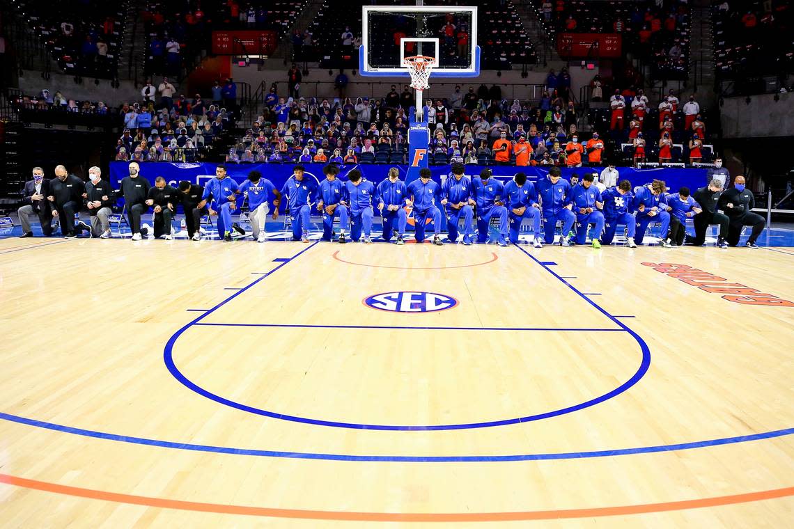 Kentucky’s players and coaches kneeled during the national anthem ahead of the team’s game against Florida on Saturday, Jan. 9, 2021, in Gainesville.