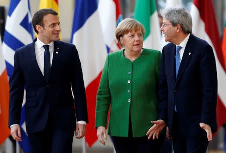 French President Emmanuel Macron, Germany's Chancellor Angela Merkel and Italy's Prime Minister Paolo Gentiloni arrive at a European Union heads of state informal meeting in Brussels, Belgium, February 23, 2018. REUTERS/Francois Lenoir