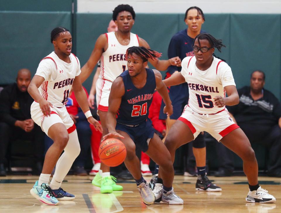 Binghamton's Kashif Summers Jr. (20) is surrounded by Peekskill defenders as he tries to drive to the basket during the state Class AA subregional playoff game at Yorktown High School March 6, 2024. Peekskill won the game 53-52.
