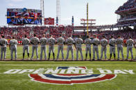 FILE - In this March 28, 2019, file photo, the Pittsburgh Pirates lineup for the national anthem before an opening day baseball game against the Cincinnati Reds, in Cincinnati. To baseball fans, opening day is an annual rite of spring that evokes great anticipation and warm memories. This year's season was scheduled to begin Thursday, March 26, 2020, but there will be no games for a while because of the coronavirus outbreak. (AP Photo/Gary Landers, File)