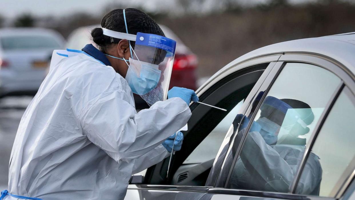PHOTO: Nurse practitioner Deborah Beauplan administers a COVID-19 swab test at a drive-thru testing site at Smith Point Park, Dec. 19, 2020, in Shirley, N.Y. (Newsday Llc/Newsday via Getty Images)