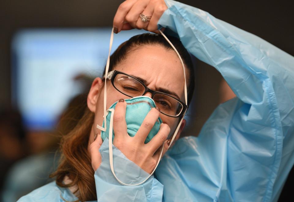 Nurse Viviana Castano tries on a mask during training to deal with COVID-19 at Holy Name Medical Center in Teaneck, N.J., on Feb. 24.