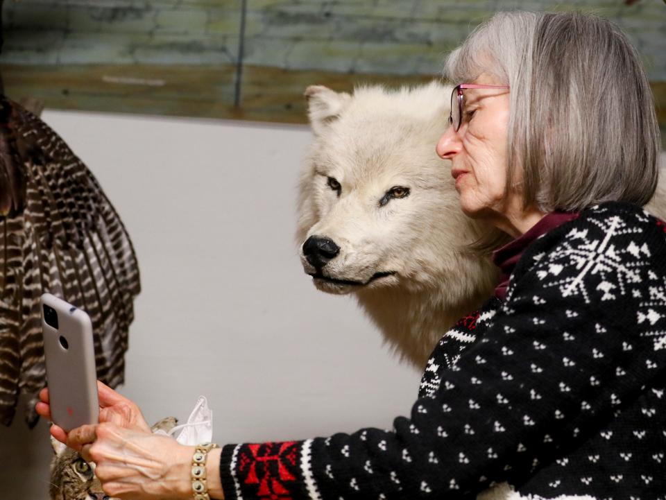 Marsha Berenson takes a selfie with a timber wolf at the 2022 Milwaukee Journal Sentinel Sports Show.