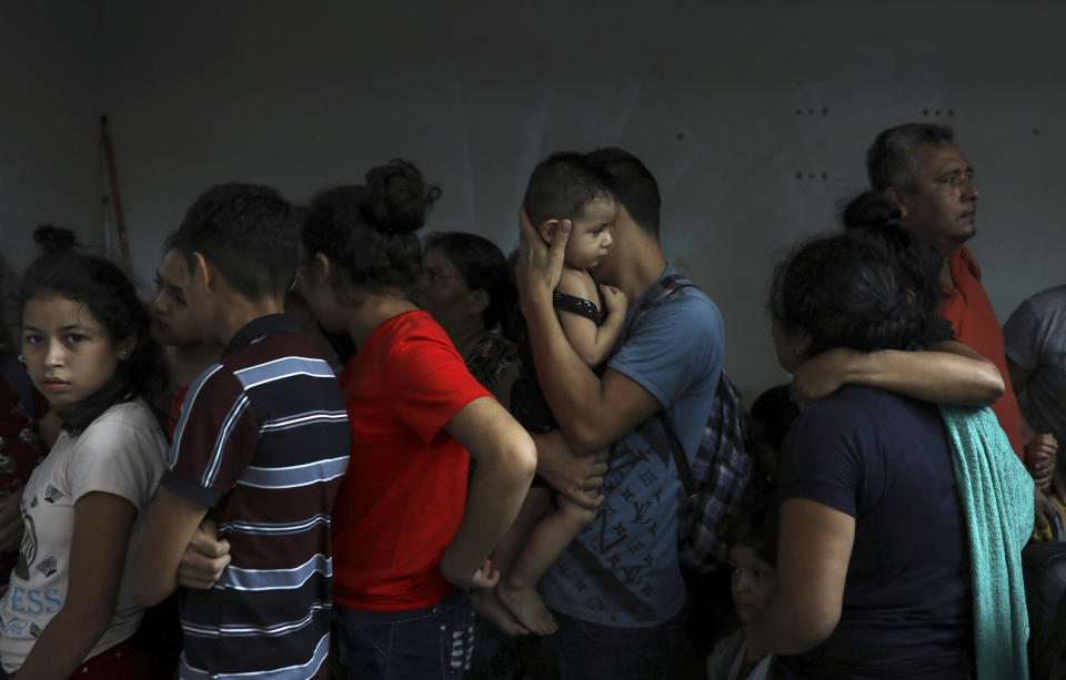 Detained migrants huddle together in a storage room at the back of the Azteca Hotel where they tried to hide from Mexican immigration agents conducting a raid, in Veracruz, Mexico, Thursday, June 27, 2019. Under increasing U.S. pressure to reduce the flow of hundreds of thousands of Central Americans through Mexican territory, Mexico's government has stepped up enforcement. (AP Photo/Felix Marquez)