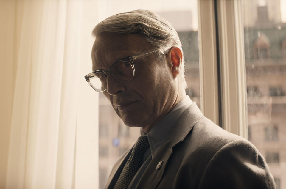 Jürgen Voller, a.k.a. Dr. Schmidt (Mads Mikkelsen), seen here wearing a NASA lapel pin, is a former Nazi scientist who led development of the rocket that took the Apollo astronauts to the moon in 