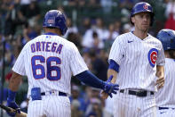 Chicago Cubs' Matt Duffy, right, celebrates with Rafael Ortega after scoring on a sacrifice fly by David Bote during the fourth inning of a baseball game against the St. Louis Cardinals in Chicago, Sunday, Sept. 26, 2021. (AP Photo/Nam Y. Huh)