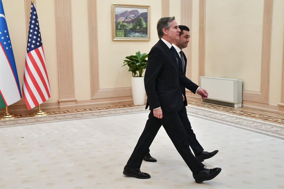U.S. Secretary of State Antony Blinken, foreground, and Uzbekistan Acting Foreign Minister Bakhtiyor Saidov walk for the talks after posing for a photo during their meeting at the National Library in Tashkent, Uzbekistan, Wednesday, March 1, 2023. (AP Photo)