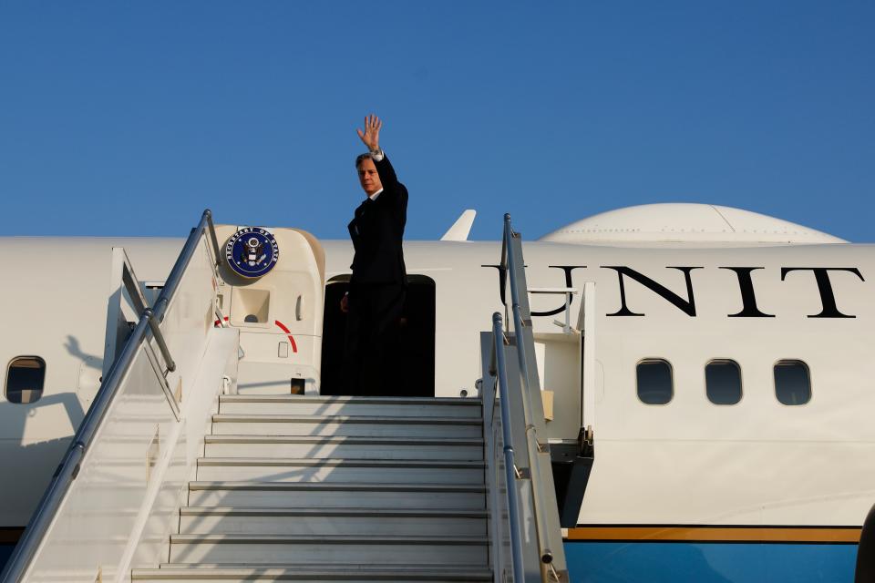 US Secretary of State Antony Blinken waves as he boards his plane to depart after meetings in West Bank