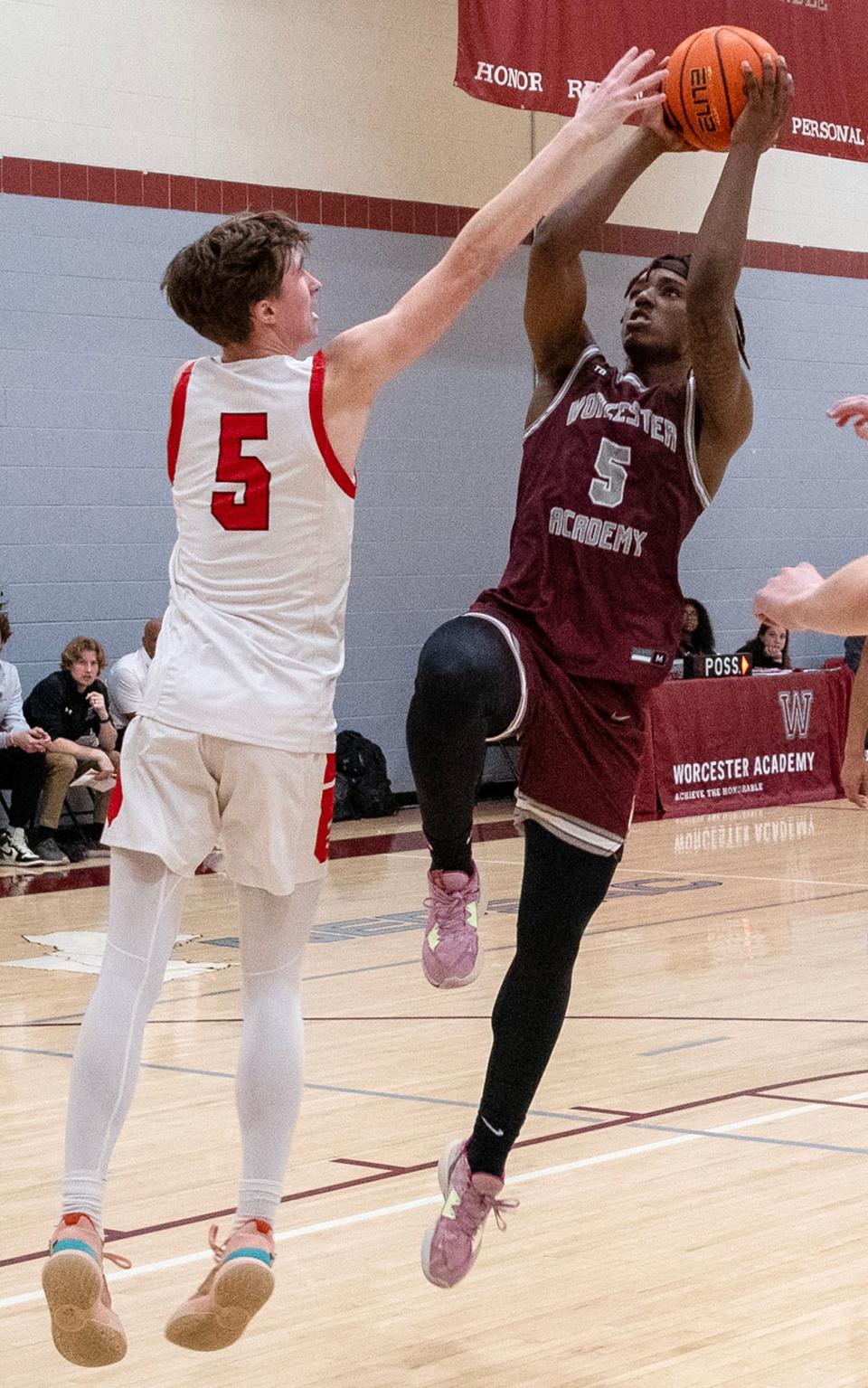 Worcester Academy's Tre Norman shoots a block attempt by St. George's Barrett Loer.