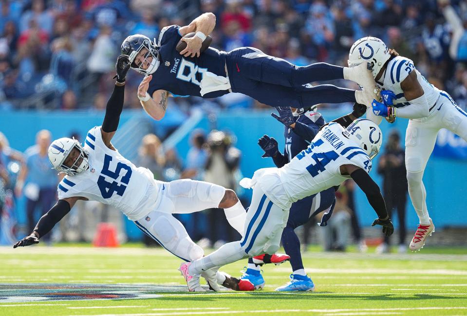 Tennessee Titans quarterback Will Levis (8) scrambles and jumps over Indianapolis Colts linebacker E.J. Speed (45), linebacker Zaire Franklin (44) and cornerback Kenny Moore II (23), during NFL week 13 at Nissan Stadium in Nashville, Tenn.