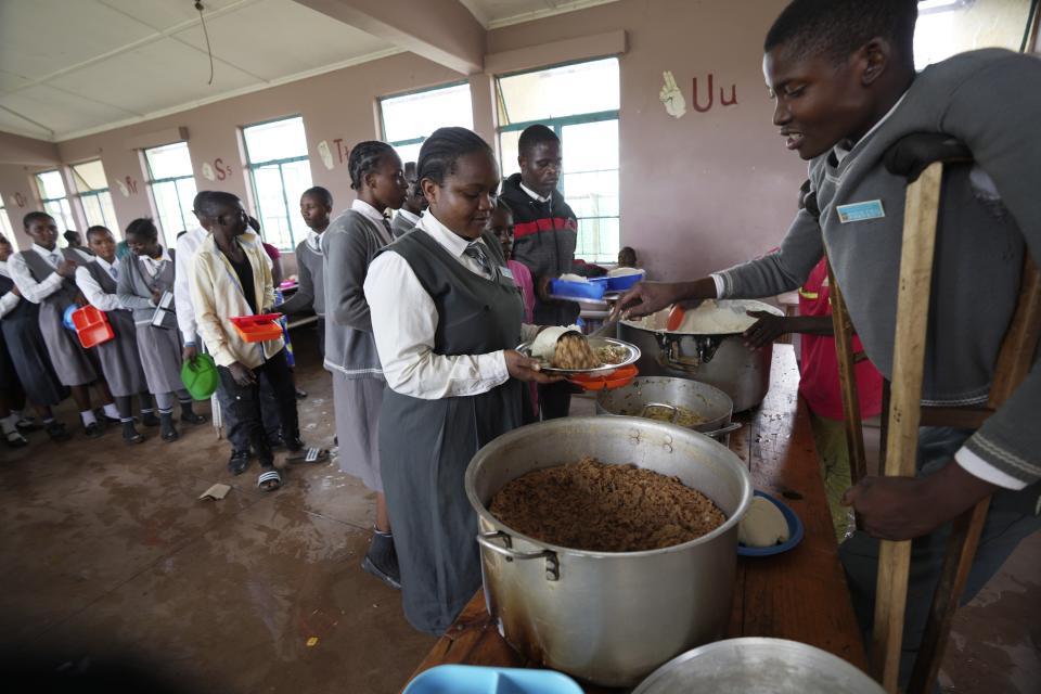Bridget Chanda is served her lunch meal at Chileshe Chepela Special School in Kasama, Zambia, Thursday, March 7, 2024. (AP Photo/Tsvangirayi Mukwazhi)