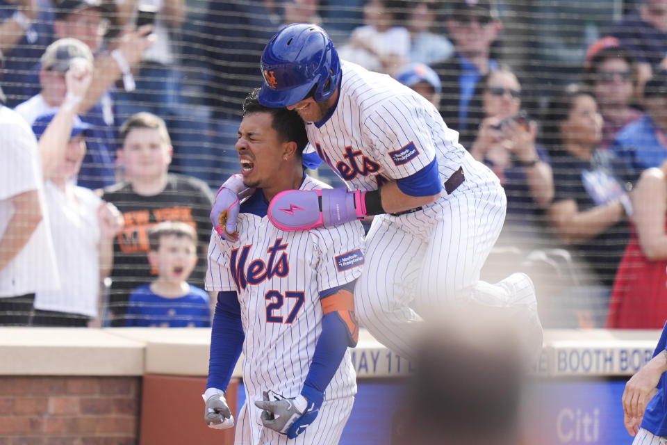 New York Mets Mark Vientos (27), left, celebrates with Harrison Bader after hitting a walk-off home run during the 11th inning of a baseball game against the St. Louis Cardinals at Citi Field, Sunday, April 28, 2024, in New York. (AP Photo/Seth Wenig)