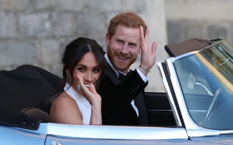 Prince Harry appears to have given his bride a poignant wedding day gift - an impressive, emerald cut aquamarine ring which belonged to his late, beloved mother. Ms Markle wore the large gem on her right hand as the couple made their way to their evening reception - Credit: Steve Parsons/PA