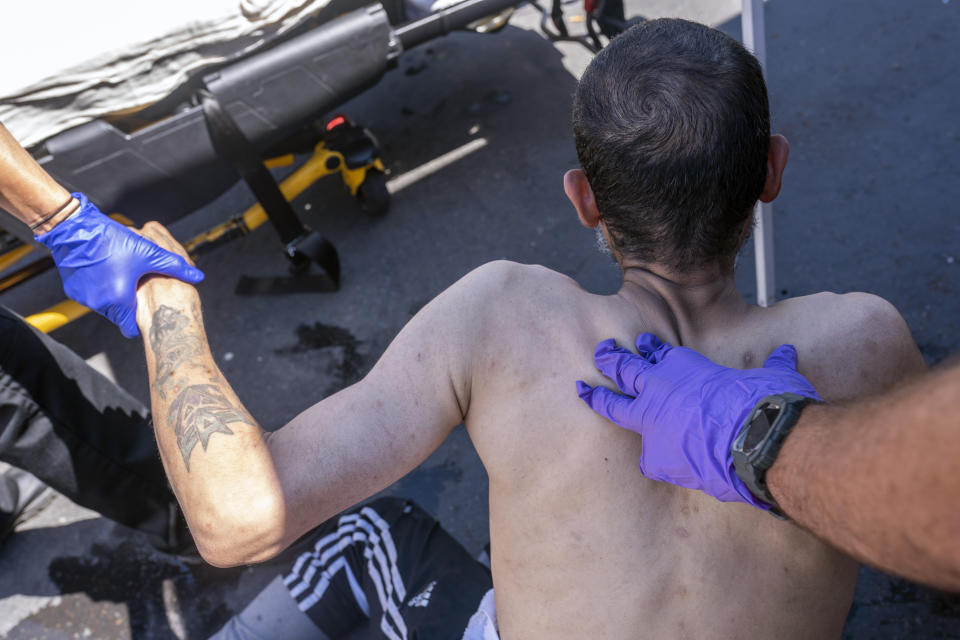 Salem Fire Department paramedics respond to a heat exposure call at a cooling center during a heat wave, Saturday, June 26, 2021, in Salem, Ore. (AP Photo/Nathan Howard)