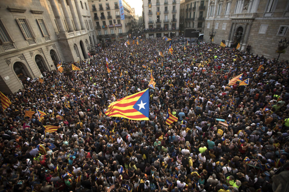 <p>People wave “estelada” or pro independence flags outside the Palau Generalitat in Barcelona, Spain, after Catalonia’s regional parliament passed a motion with which they say they are establishing an independent Catalan Republic, Friday, Oct. 27, 2017. (Photo: Emilio Morenatti/AP) </p>