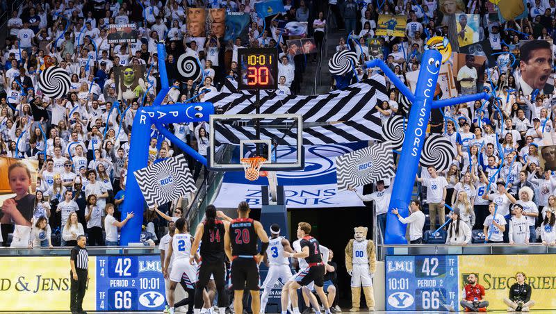 BYU’s student section hold up signs as Loyola Marymount forward Keli Leaupepe (34) shoots a free throw during game at the Marriott Center in Provo on Thursday, Feb. 2, 2023.